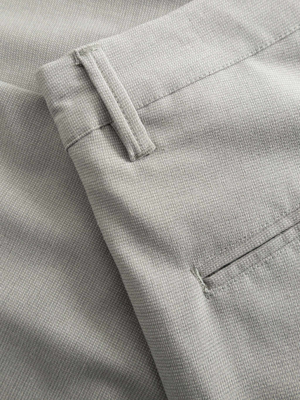 Close-up of the Gabba GABpaul Deme Pant in Mineral Gray, a slim-fit trouser with belt loops and back pocket, crafted from fine micro-pattern woven fabric featuring subtle two-tone detailing.