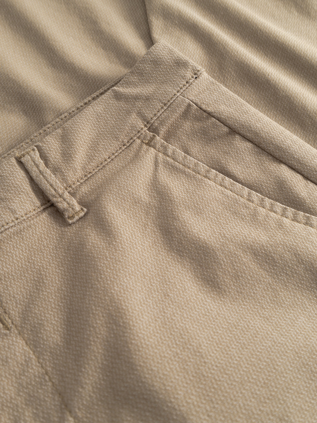 Close-up of the GABpaul K3280 Dale Chino in Sand by Gabba, showcasing the waistband, belt loop, French pockets with visible stitching, and textured beige fabric.