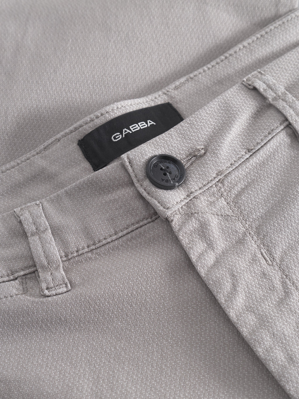 Close-up of Gabba Paul K3280 Dale Chino in Grey Paloma with French pockets, visible button, and black label above the waistband. Fabric texture and stitching details are highlighted.