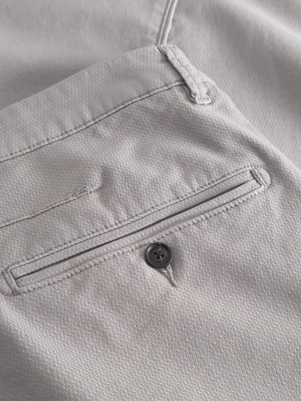 Close-up of Gabbas Paul K3280 Dale Chino in Grey Paloma, featuring a slim fit, fabric back pocket with thin welt, black button closure, visible stitching, and French pockets for a modern look.