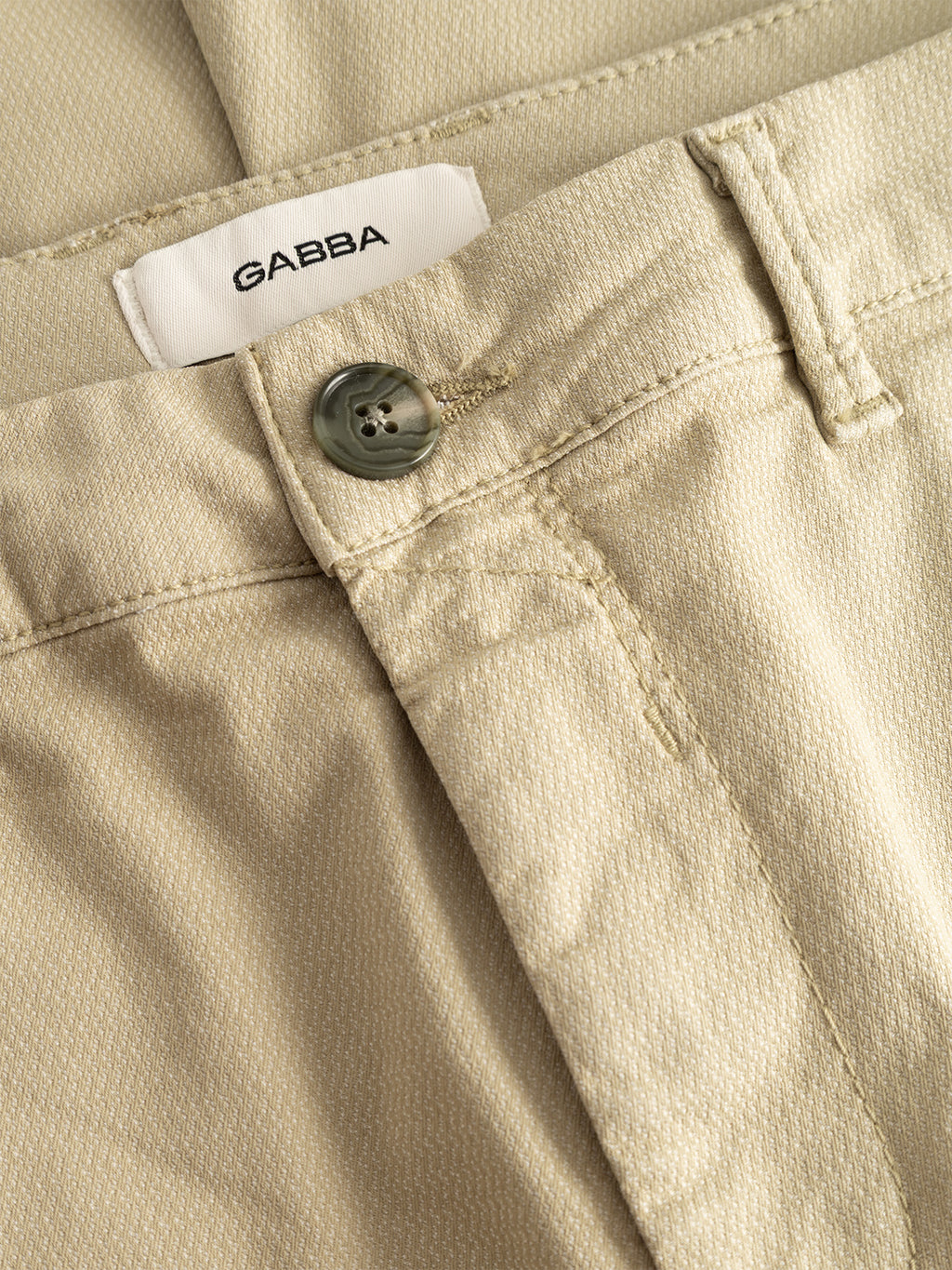 Close-up of GABpaul K3280 Dale Chino - Alfa Green by Gabba, showing textured slim fit, visible waistband, button, belt loop, classic French pockets, and a white GABBA label sewn inside.
