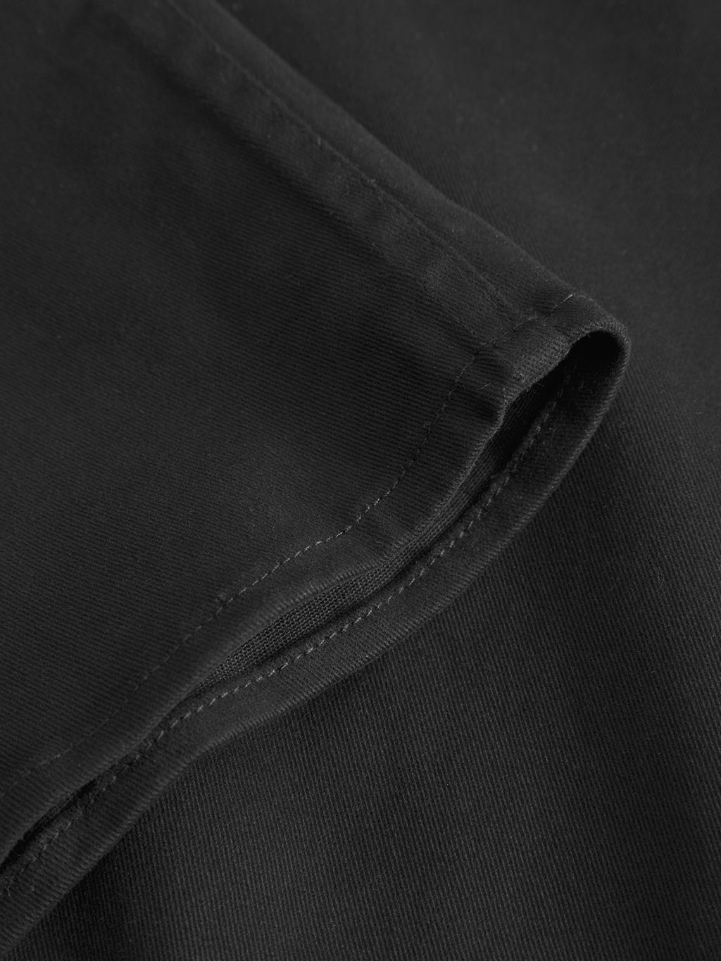 Close-up of the GABBA Topper LS Shirt in black, highlighting the visible stitching and neatly sewn hem—an ideal overshirt for layering all year round.