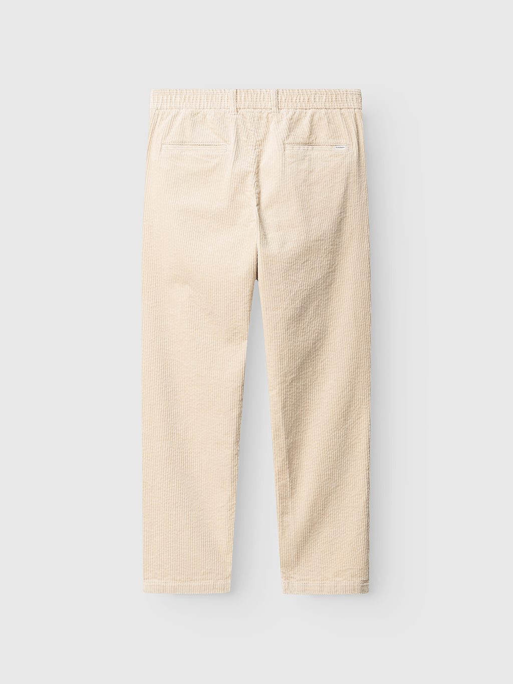 Back view of the Gabba GABnapoli 19 Ibre Pant in Birch, featuring beige cotton corduroy with an elastic waistband and two back welt pockets, displayed against a plain light gray background.
