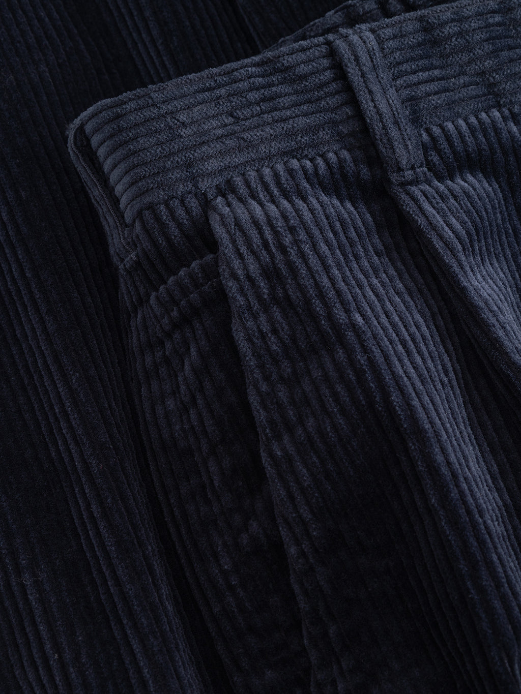 Close-up of dark navy GABnapoli 19 Ibre Pant straight fit cotton corduroy trousers showing the waistband, belt loop, and front pocket.