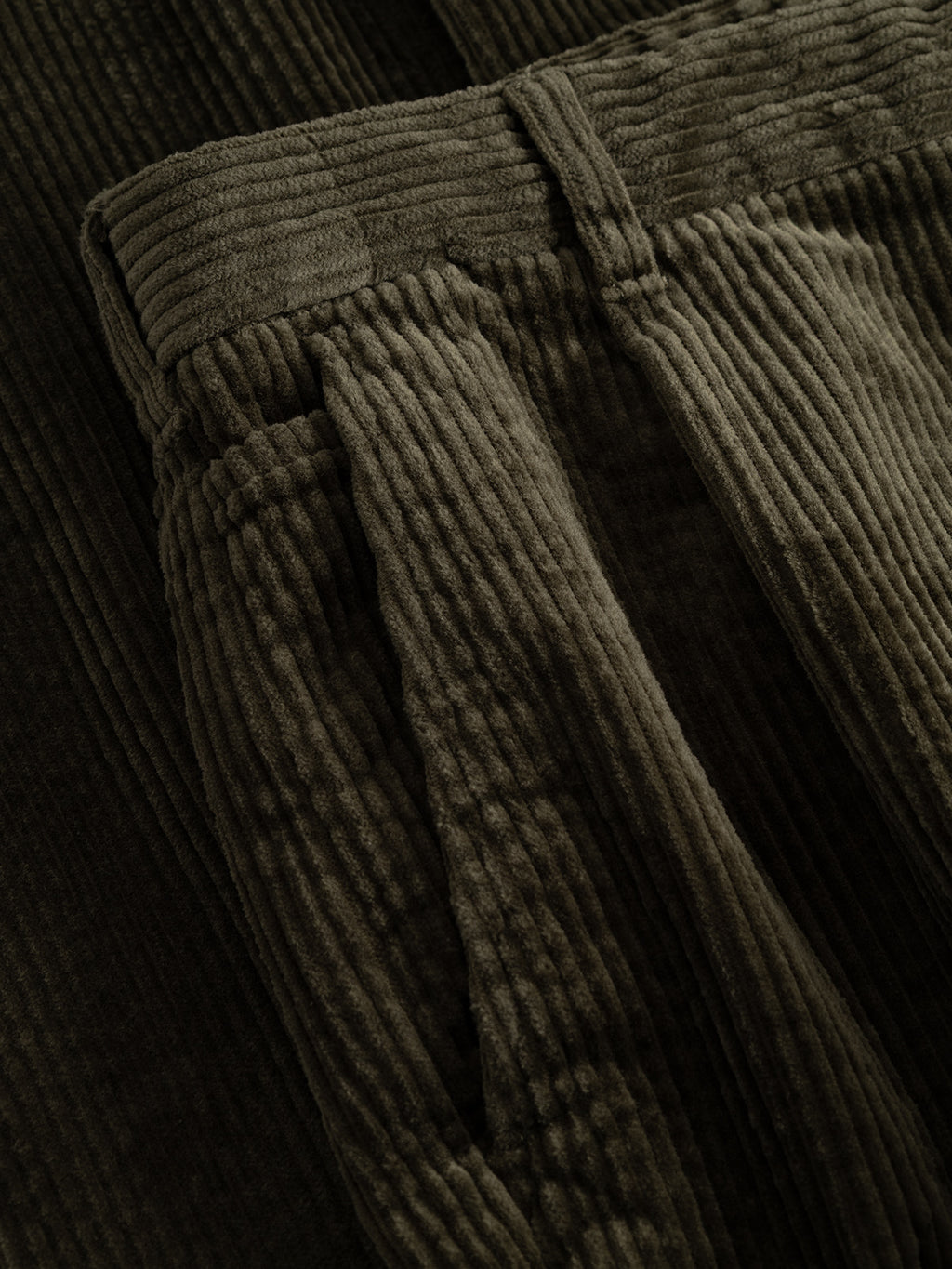 Close-up of the GABnapoli 19 Ibre Pant in Forest Night by Gabba, highlighting the rich texture of the brown cotton corduroy fabric, detailed waistband, belt loop, and pocket—expertly crafted in a straight fit for a timeless men’s tailored look.