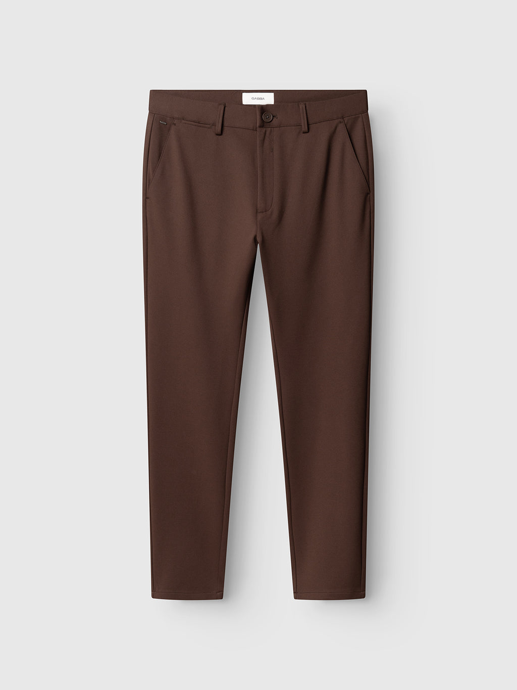 The Gabba GABpaul Dotty Pant in Brown Slate is a pair of slim-fit chino trousers made from superstretch fabric, designed with side pockets, belt loops, and a button closure, shown against a plain light gray background.