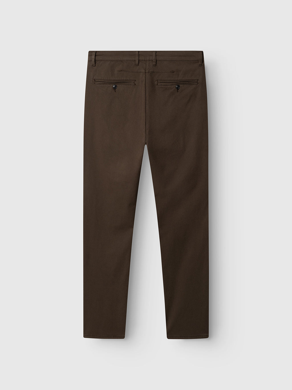 Back view of Gabba GABpaul K3280 Dale Chino in dark brown, featuring two buttoned welt pockets and a slim leg opening, displayed against a plain light gray background.