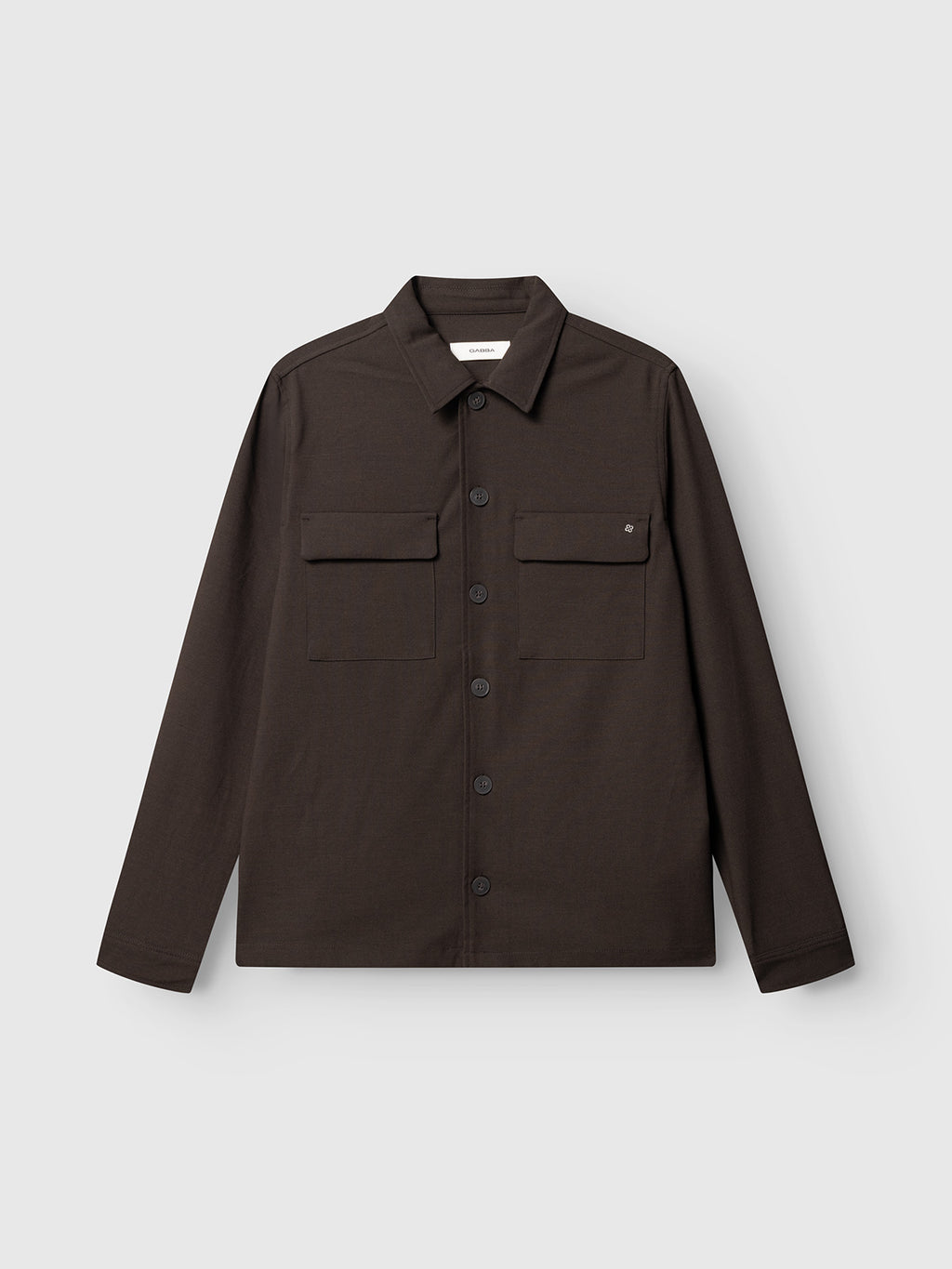 The Gabba GABtogger Push Phin LS Overshirt GRS in Brown Slate is a long-sleeved, regular-fit button-up with a collar and two front chest pockets, expertly crafted from a soft wool-viscose blend for lasting comfort and durability. Perfect for layering, it’s showcased here against a plain, light gray background.